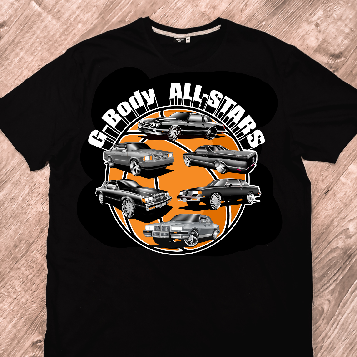 A T-shirt featuring an Oldsmobile Cutlass Supreme, El Camino, Monte Carlo SS, Pontiac Grand Prix, Chevy Malibu, and a Buick Regal. All cars are on 24-inch wheels.
